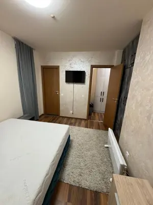 a bedroom with a bed and a flat screen tv at JMN Pamporovo in Pamporovo