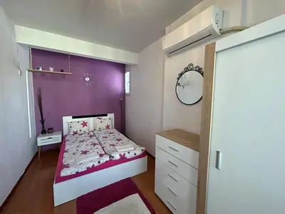a bedroom with a bed and a purple wall at Cozy Stay Sofia Historic Center in Sofia