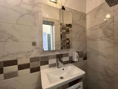 a bathroom with a sink and a mirror at Cozy Stay Sofia Historic Center in Sofia