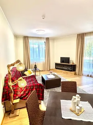 a living room with a couch and a table at Alpine Charm Borovets Apart in Borovets