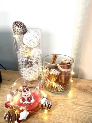 a table with two glass vases with christmas decorations at Alpine Charm Borovets Apart in Borovets