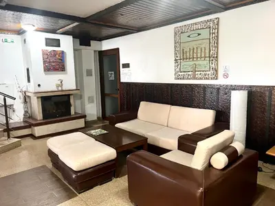 a living room with a couch and a table at Slope nest Bansko in Bansko