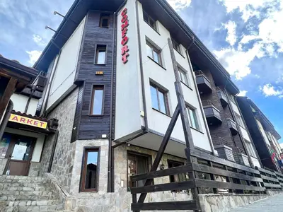 a building with a sign on the side of it at Slope nest Bansko in Bansko
