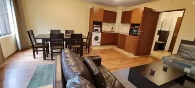 a living room with a couch and a table and chairs at Slope nest Bansko in Bansko