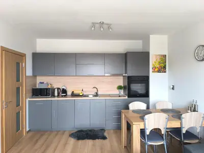 a kitchen with a table and a dining room at Апартамент Славяна in Velingrad