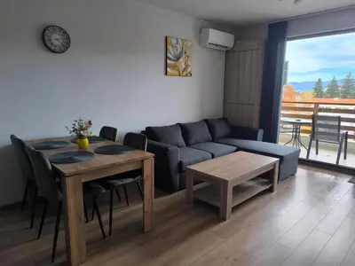 a living room with a couch and a table at Апартамент Славяна in Velingrad