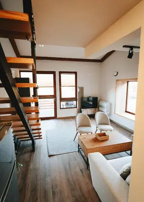 a living room with a couch and a table at ЕКО Къщи Марциганица in Dobrostan