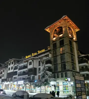 a building with a christmas tree in front of it at Bansko Royal Towers apartment Star in Bansko