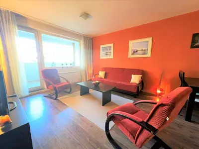 a living room with a red couch and chairs at Bansko Royal Towers apartment Star in Bansko