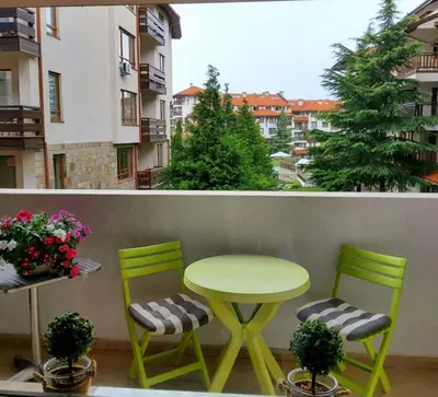 a green table and two chairs on a balcony at Bansko Royal Towers apartment Star in Bansko