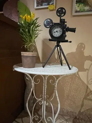 a table with a camera and a clock on it at Hotel MERIDA in Blagoevgrad