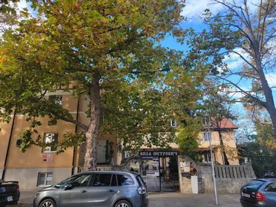 a silver car parked in front of a building at Стаи за гости Писателите in Hisarya