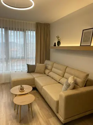 a living room with a couch and a table at Villa Vitosha Apartments in Hisarya
