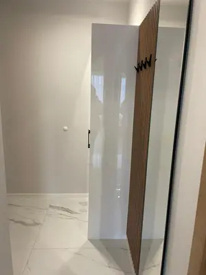 a glass elevator in a room with white walls at Villa Vitosha Apartments in Hisarya