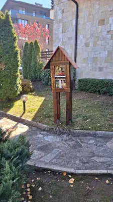 a bird feeder in a yard next to a building at Silver Ridge Studio by SI Stay in Razlog