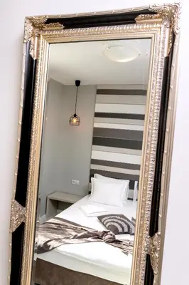 a mirror in a bedroom with a bed at Mon Ami Apart in Studentski Grad Area in Sofia