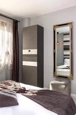 a bedroom with a large mirror and a bed at Mon Ami Apart in Studentski Grad Area in Sofia