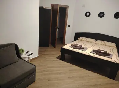 a living room with a bed and a couch at Вила Анжелика in Ilinden