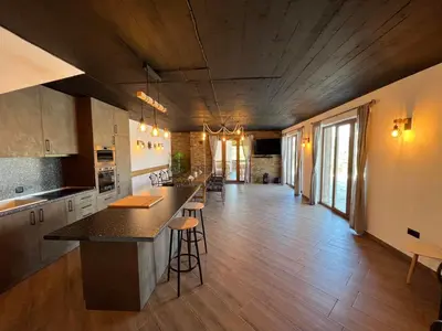 a large kitchen with a counter and a long hallway at Вила Анжелика in Ilinden