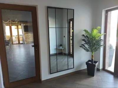 a glass door in a room with a potted plant at Вила Анжелика in Ilinden