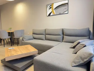 a living room with a couch and a table at Modern & Spacious Two-Bedroom Apartment in Plovdiv