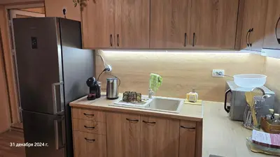 a kitchen with a sink and a refrigerator at Suite Roma 3 in Velingrad
