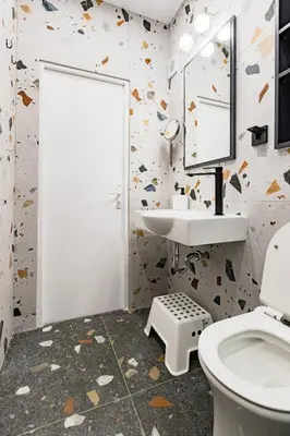 a bathroom with a toilet and a sink and a mirror at Space art apart in Sofia