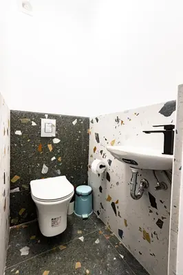 a bathroom with a toilet and a sink at Space art apart in Sofia