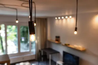 a living room with two lights and a fireplace at Space art apart in Sofia