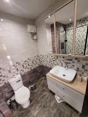 a bathroom with a toilet and a sink at New apartment with a great view in Sofia