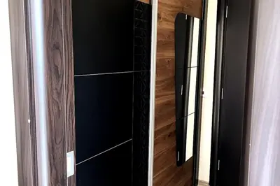 two pictures of a glass shower door in a room at New apartment with a great view in Sofia