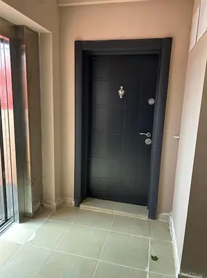 a black door in a room with a tile floor at New apartment with a great view in Sofia