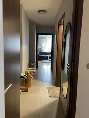 a hallway with a door leading to a living room at Blavka apartment Gardenia in Sofia