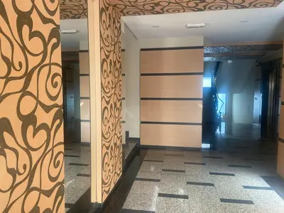 a hallway with wooden doors in a building at Blavka apartment Gardenia in Sofia
