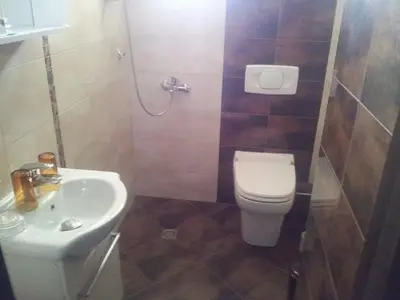 a small bathroom with a toilet and a sink at Guest House Veni in Blagoevgrad