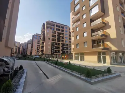 an empty street in a city with tall buildings at Апартамент тип хотелска стая in Plovdiv