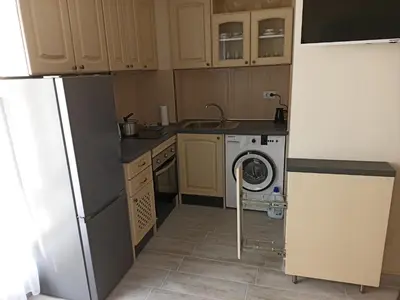 a kitchen with a refrigerator and a washing machine at Апартамент тип хотелска стая in Plovdiv