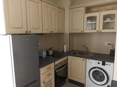 a kitchen with a refrigerator and a washing machine at Апартамент тип хотелска стая in Plovdiv