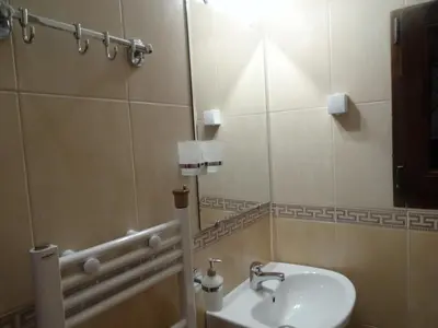 a bathroom with a sink and a mirror at Ognyanovata Guest House in Dobărsko