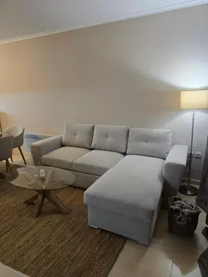 a living room with a couch and a table at Костадинов 2 in Pamporovo