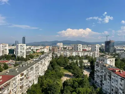 a view of a city with tall buildings and trees at Magnolia city view studio in Sofia