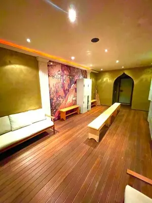 a room with benches and a painting on the wall at Костадинов 1 in Pamporovo