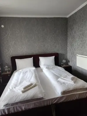 a bedroom with two beds with towels on them at Костадинов 1 in Pamporovo