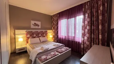 a small bedroom with a bed and a window at Stylish 2 BR apart in top center in Sofia