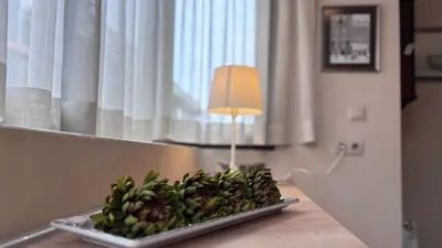 a plate of fruit on a table with a lamp at Stylish 2 BR apart in top center in Sofia
