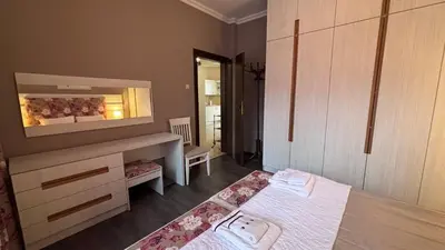 a room with a bed and a vanity and a mirror at Stylish 2 BR apart in top center in Sofia