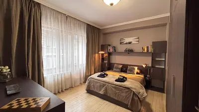 a bedroom with a bed and a checkeredkered at Stylish 2 BR apart in top center in Sofia