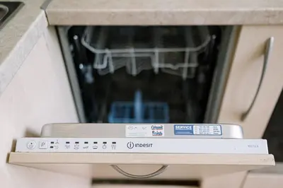 a close up of a stove top oven with a book at Grand Luxury Condo by NDK and National Stadium with Free Parking in Sofia