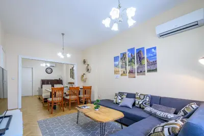 a living room with a blue couch and a table at Grand Luxury Condo by NDK and National Stadium with Free Parking in Sofia