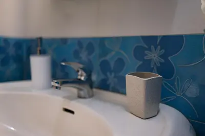 a bathroom sink with a roll of toilet paper on it at Grand Luxury Condo by NDK and National Stadium with Free Parking in Sofia